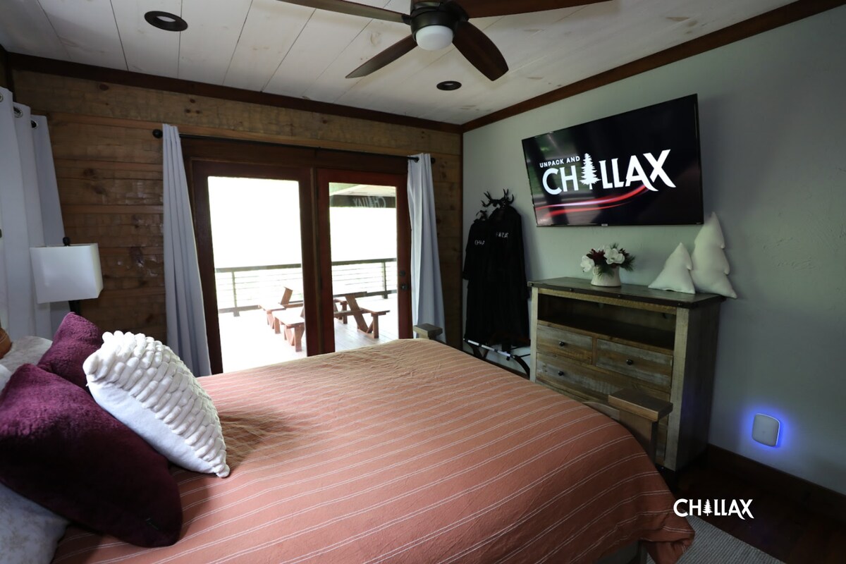Queen-sized bedroom (main level) offers a TV, ceiling fan, and balcony access.