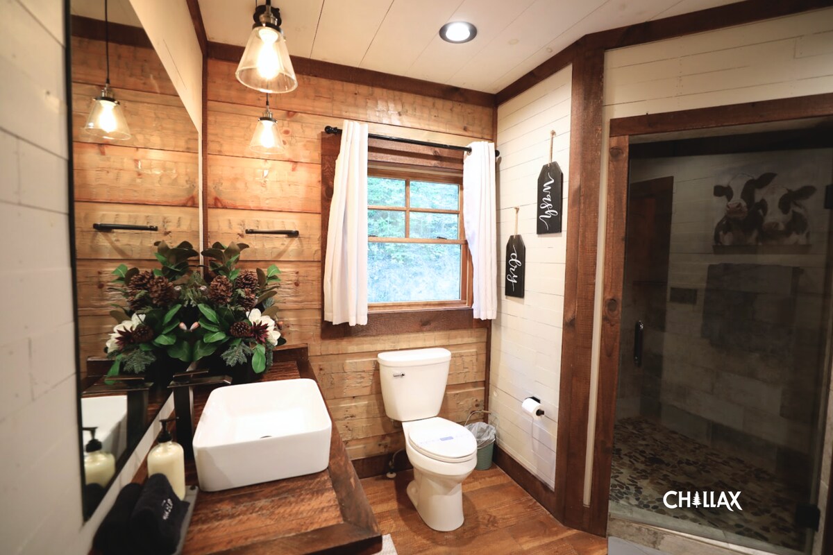Enjoy stepping into this spa-like (main-level) bathroom with a rainfall shower, where the refreshing scents of flowers and nature create a tranquil ambiance.