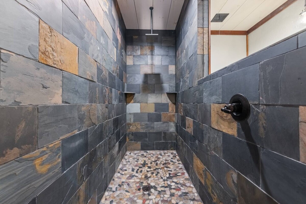 The infamous rain shower is located in the (lower-level) bathroom.